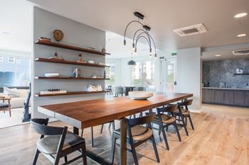 a dining room with a long wooden table and chairs